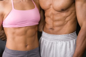 Cuts Right To The Core: Close up photo of a fitness couple's abs.