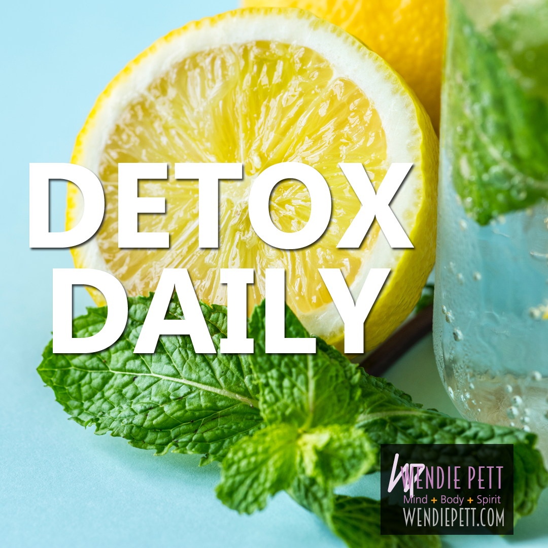 Close up of a lemon cut in half with overlaid text that reads, "detox daily"