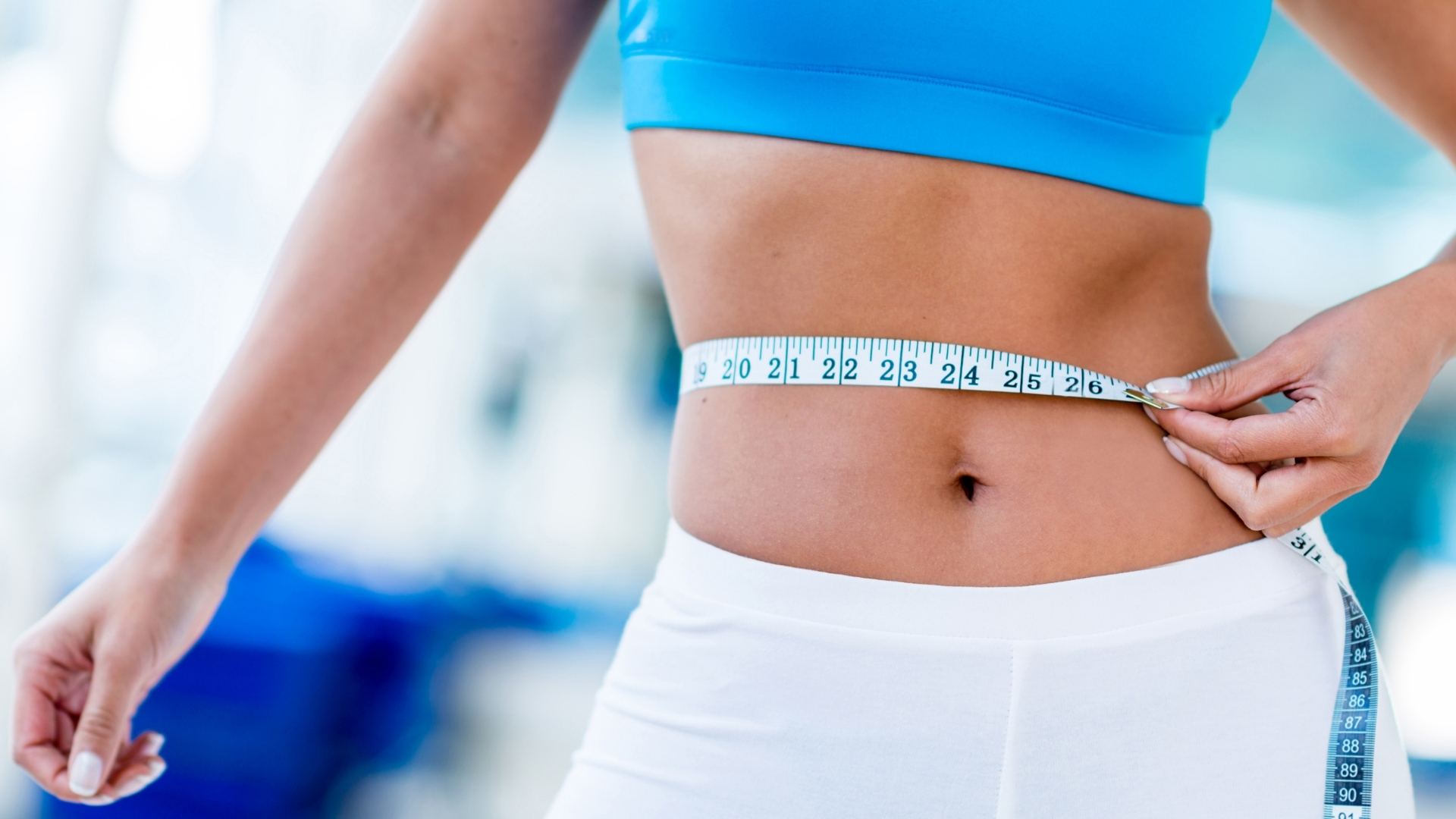 Close up of woman measuring waist to represent how to get Get Visibly Fit™ with Wendie Pett, ND